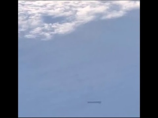 Cylinder Shaped UFO Recorded From Passing Passenger Plane!