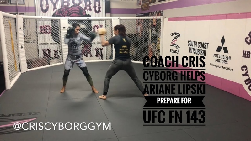 Cris Cyborg holds pads for Ariane Lipski ahead of UFC FN